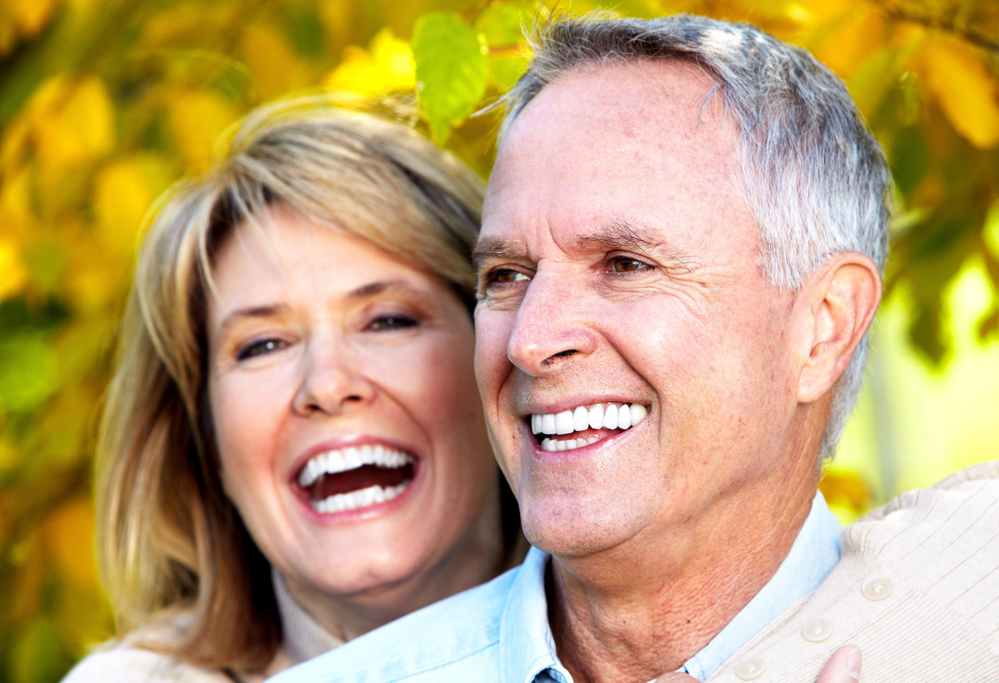 elderly couple smiling outdoors