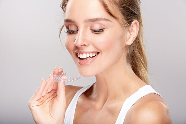 woman with an invisalign tray